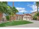Desert home featuring a well maintained lawn and three car garage at 1324 European Dr, Henderson, NV 89052