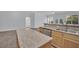An open kitchen featuring granite counters, an eat-in bar, and hardwood floors overlooking the living space at 1324 European Dr, Henderson, NV 89052
