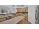 A spacious kitchen with granite countertops, stainless steel appliances, and natural wood cabinetry at 1324 European Dr, Henderson, NV 89052