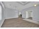 Open-concept living room featuring wood floors, modern lighting, and neutral paint at 1324 European Dr, Henderson, NV 89052