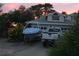 Home featuring a boat on a trailer and a pickup truck in the driveway at 1385 Ringe Ln, Las Vegas, NV 89110