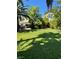 Landscaped front yard with a well-maintained lawn and mature trees, offering curb appeal at 1385 Ringe Ln, Las Vegas, NV 89110