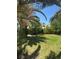 Lush front yard features trees providing shade and complementing the home's exterior at 1385 Ringe Ln, Las Vegas, NV 89110