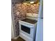 A close-up view of the kitchen, featuring a white stove and backsplash with brick-style tiles at 1385 Ringe Ln, Las Vegas, NV 89110