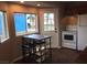 Bright kitchen boasts tiled floors and a dining area near windows with backyard views at 1385 Ringe Ln, Las Vegas, NV 89110
