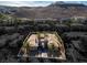An aerial view of a luxury home with mature landscaping, set against a desert backdrop at 1665 Liege Dr, Henderson, NV 89012