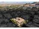Birds-eye view of a grand residence showcasing its manicured grounds and desert surroundings at 1665 Liege Dr, Henderson, NV 89012