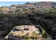Aerial view of a luxurious residence featuring a tile roof and lush palm tree landscaping at 1665 Liege Dr, Henderson, NV 89012