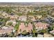 A luxurious home with desert landscaping and a tile roof, situated in an upscale community at 1665 Liege Dr, Henderson, NV 89012