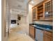 Wet bar area complete with a sink, mini-fridge, and glass-front cabinets at 1665 Liege Dr, Henderson, NV 89012