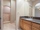 Bathroom features a granite countertop, wooden vanity, walk-in shower, and neutral color palette at 1665 Liege Dr, Henderson, NV 89012