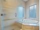 Bathroom showcases a jacuzzi tub, privacy windows, and glass-enclosed shower at 1665 Liege Dr, Henderson, NV 89012