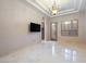 Bedroom features tile floors, modern chandelier, shuttered windows, and walk-in closet at 1665 Liege Dr, Henderson, NV 89012