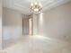 Bright bedroom features tile floors, contemporary lighting, neutral paint, and ensuite bathroom at 1665 Liege Dr, Henderson, NV 89012
