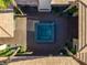 Overhead shot of courtyard featuring spa, neutral pavers, and symmetrical desert landscaping at 1665 Liege Dr, Henderson, NV 89012