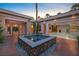 Charming courtyard featuring a decorative water feature, lush plants, and access to multiple living spaces at 1665 Liege Dr, Henderson, NV 89012