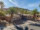Exterior of home with palm trees and a gated entrance at 1665 Liege Dr, Henderson, NV 89012