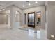 Bright and airy foyer with marble floors, arched doorways, and an ornate front door with sidelights at 1665 Liege Dr, Henderson, NV 89012