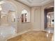 Arched hallways lead to spacious rooms with elegant lighting fixtures at 1665 Liege Dr, Henderson, NV 89012