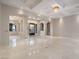 Bright living room with marble flooring, high ceilings, recessed lights, and decorative entry door at 1665 Liege Dr, Henderson, NV 89012