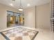 An inviting living room features sleek tile flooring, accent lighting, and outdoor views at 1665 Liege Dr, Henderson, NV 89012