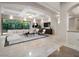 Bright living room boasts recessed lighting, coffered ceilings, and large windows overlooking lush greenery at 1665 Liege Dr, Henderson, NV 89012