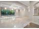 Bright living room boasts recessed lighting, coffered ceilings, and large windows overlooking lush greenery at 1665 Liege Dr, Henderson, NV 89012