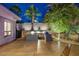 Well-designed outdoor kitchen featuring a grill, bar area, and palm tree views at twilight at 1665 Liege Dr, Henderson, NV 89012