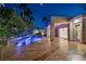 Sparkling pool area with a modern pool design, lush landscaping, and a covered patio at 1665 Liege Dr, Henderson, NV 89012
