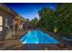 Inviting swimming pool surrounded by lush greenery, stone accents, and a spacious patio area at 1665 Liege Dr, Henderson, NV 89012