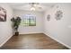 Bedroom view featuring wood floors, a ceiling fan, and wall decor at 1830 N Buffalo Dr # 1031, Las Vegas, NV 89128