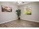 Bedroom boasts wood floors, a ceiling fan, and a window with a view at 1830 N Buffalo Dr # 1031, Las Vegas, NV 89128