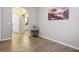 Bedroom with wood floors, neutral walls, and an open doorway at 1830 N Buffalo Dr # 1031, Las Vegas, NV 89128