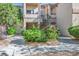 Exterior view of a multi-level building with landscaped grounds and wrought iron staircases at 1830 N Buffalo Dr # 1031, Las Vegas, NV 89128