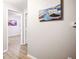Hallway view with neutral walls and modern vinyl flooring leading to a well-lit room at 1830 N Buffalo Dr # 1031, Las Vegas, NV 89128