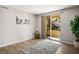 Bright living area with a sliding glass door leading to the outside, wood-look floors, and neutral decor at 1830 N Buffalo Dr # 1031, Las Vegas, NV 89128
