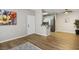 Open-concept living area showcasing hardwood floors, white cabinets and stainless steel appliances at 1830 N Buffalo Dr # 1031, Las Vegas, NV 89128