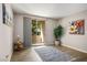 Well-lit living area featuring hardwood floors, a sliding glass door, and tasteful decorative accents at 1830 N Buffalo Dr # 1031, Las Vegas, NV 89128