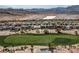 Beautiful aerial view of home on the golf course with mountain views in the background at 2080 Orchard Mist St, Las Vegas, NV 89135