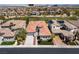 View of the home's tile roof in a desert community near a golf course with city views in the distance at 2080 Orchard Mist St, Las Vegas, NV 89135