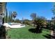 Landscaped backyard features a sparkling pool, spa, and well-maintained green space, perfect for outdoor relaxation at 2080 Orchard Mist St, Las Vegas, NV 89135
