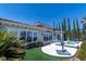 Inviting backyard featuring a pool, spa, covered patio, and lush landscaping at 2080 Orchard Mist St, Las Vegas, NV 89135