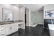 Well-lit bathroom featuring marble counters, a glass-enclosed shower, and free-standing tub at 2080 Orchard Mist St, Las Vegas, NV 89135