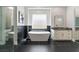 Modern bathroom with elegant soaking tub, marble accents, and walk-in glass shower at 2080 Orchard Mist St, Las Vegas, NV 89135
