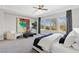 Bright, carpeted bedroom with large windows, stylish furnishings, and modern ceiling fan at 2080 Orchard Mist St, Las Vegas, NV 89135