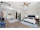 Open-concept bedroom features a bed, living area, and wood floors, filled with natural light at 2080 Orchard Mist St, Las Vegas, NV 89135