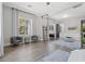 Large bedroom features hardwood floors, windows, ceiling fan, desk, and connected seating area at 2080 Orchard Mist St, Las Vegas, NV 89135