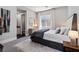 Comfortable bedroom with neutral tones, complemented by a large window, dresser, and stylish rug at 2080 Orchard Mist St, Las Vegas, NV 89135