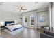 Airy bedroom with hardwood floors, seating area and well-lit arched windows overlooking the neighborhood at 2080 Orchard Mist St, Las Vegas, NV 89135