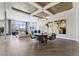 Dining room with hardwood floors, chandelier, and view to the living area through large windows at 2080 Orchard Mist St, Las Vegas, NV 89135